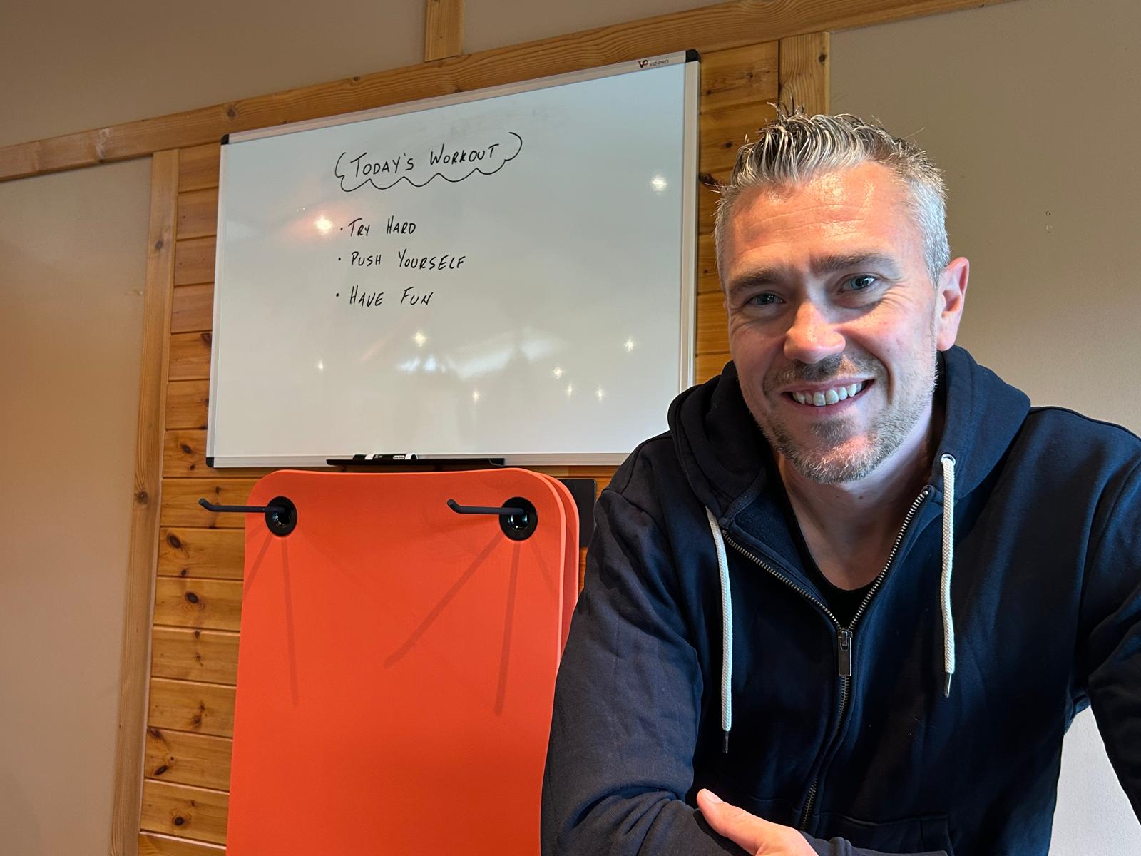 Dave at the studio whiteboard: Try Hard, Push Yourself, Have Fun